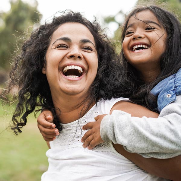 laughing mother and young daughter