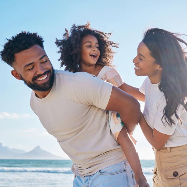 family of three on beach